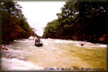 Marc McCord running the rapids on a flooded Blanco River