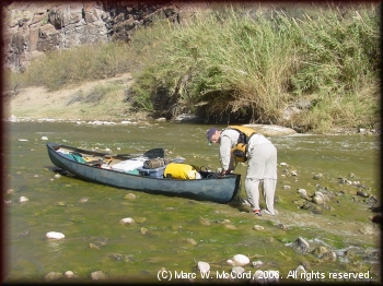 Steve Crowe dragging through a rapid in low water