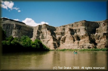 Tall sandstone canyon walls give perspective to the Green River