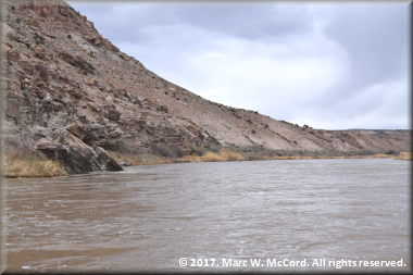 Volcanic ash piles and sandstone debris form the hills along the Gunnison River