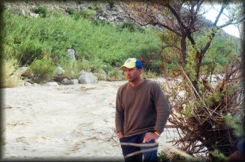 Kelly Covington pondering a fast-rising Rio Grande at Hot Springs