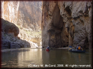 Canyon walls tower above canoeists